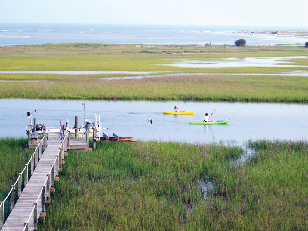 http://a%20pier%20stretches%20out%20next%20to%20kayakers%20paddling%20along%20the%20inlet%20at%20seabrook%20island