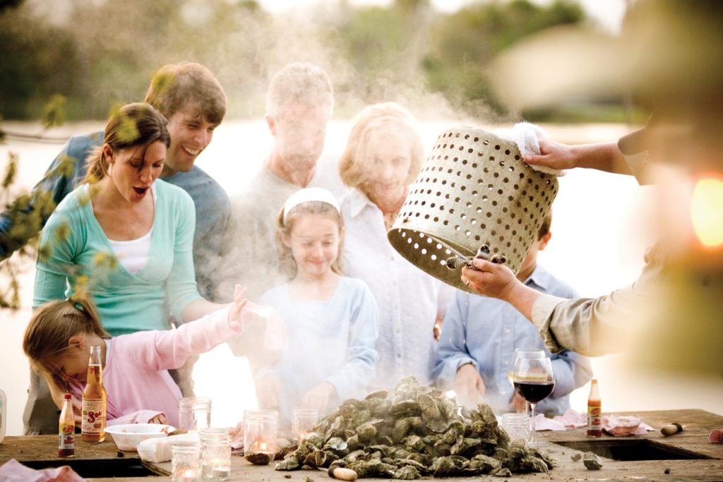 http://family%20exclaiming%20over%20steamed%20oysters%20at%20seabrook%20island