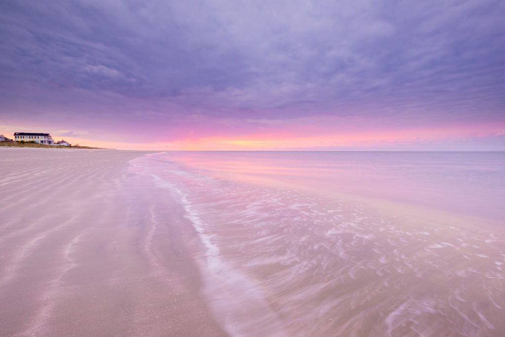 tide coming in at sunset on the beach